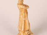 statue of a man with a hat and a robe on a pedestal