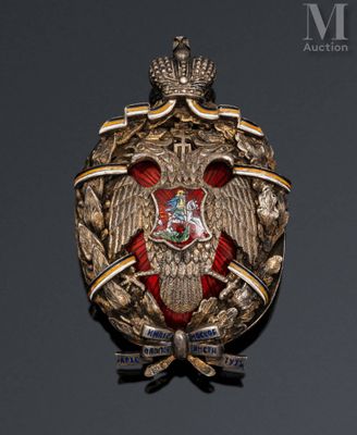 a close up of a badge on a black surface with a gray background