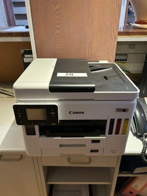 a printer that is sitting on top of a cabinet