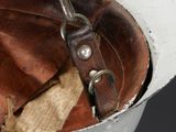 a baseball glove and glove in a bowl on a table