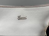 a close up of a white purse with a chain on it