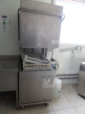 a machine that is sitting in a kitchen with a lot of stuff on the floor