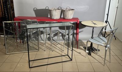 a red table and chairs in a room with a white wall