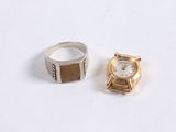 a ring and a watch sitting next to each other on a table