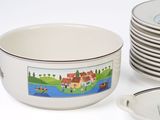 a lot of plates and bowls that are sitting on a table