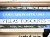 many books stacked on top of each other on a shelf