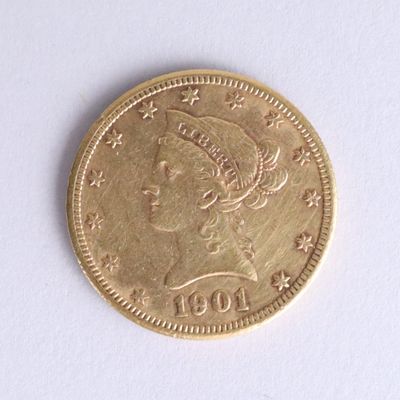 a gold coin with a woman ' s head on it