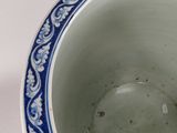 a blue and white bowl sitting on a white table