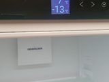 an open refrigerator with a digital clock on the door
