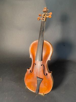 an old violin sitting on top of a table next to a wall