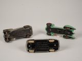 three miniature cars that are sitting on a table