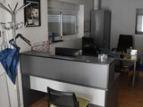 a desk with a chair and a coat rack in a room