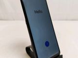 a close up of a cell phone on a stand on a table