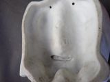 a white statue of a man with his head in the shape of a man ' s face