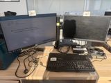two computer monitors and a keyboard on a desk