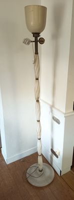 a tall lamp that is on the floor in the room