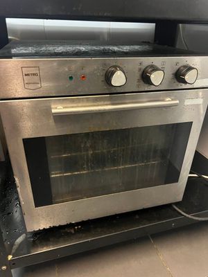 a silver oven that is sitting in the kitchen