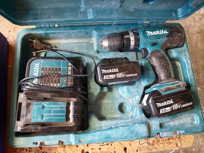 two power tools in a blue case on the floor