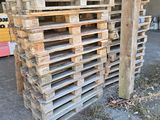 several pallets stacked up in a warehouse with a yellow fork