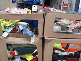 two cardboard boxes with clothes in them sitting on the floor