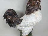 statue of a rooster on a green base with a white background