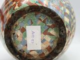 a vase with a tag on it sitting on a table