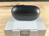 an apple airpods sitting on top of a box on top of a table