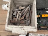 a box of tools sitting on the floor next to a box of wood