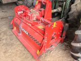a red machine that is sitting in the dirt