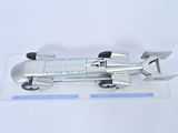 a silver model of a racing car on a clear surface