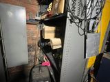 an image of a room with a refrigerator and a lot of clutter