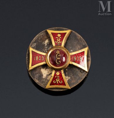 an image of a gold and red cross broochle
