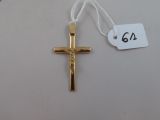 a gold cross on a white string with a price tag on it