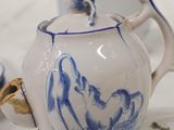 a tea pot with a blue and white design on it