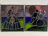 three stained glass panels depicting a man and a woman in a dress