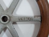 a close up of a steering wheel on a white wall