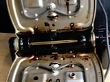 a toaster that is sitting on a table with two pans in it