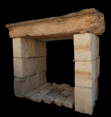 a stone fireplace in the middle of a black background
