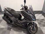 a black motorcycle that is parked on a checkered floor