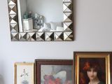 a table with pictures and a mirror on top of it