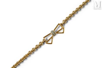 a gold bracelet with a bow and diamonds on it
