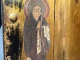 painting of a person holding a book in his hand on a piece of wood