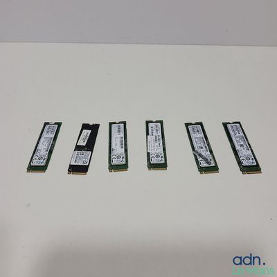 four memory modules are lined up on a white surface