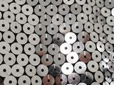 a lot of silver and silver sequins on a black surface
