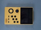 a close up of a yellow game console sitting on top of a table