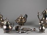 five pieces of silver tea and coffee set on a table