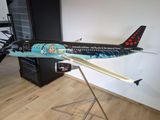 a model of an airplane on a stand in a room