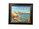 tableau à l'huile encadré représentant une côte rocheuse avec un voilier au loin