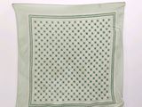 a close up of a green and white polka dot print handkerchief