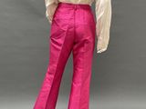 a woman in a white shirt and pink pants is standing on a mannequin mannequin